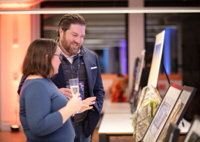 Celebration of Design attendees looking at artwork in the silent auction