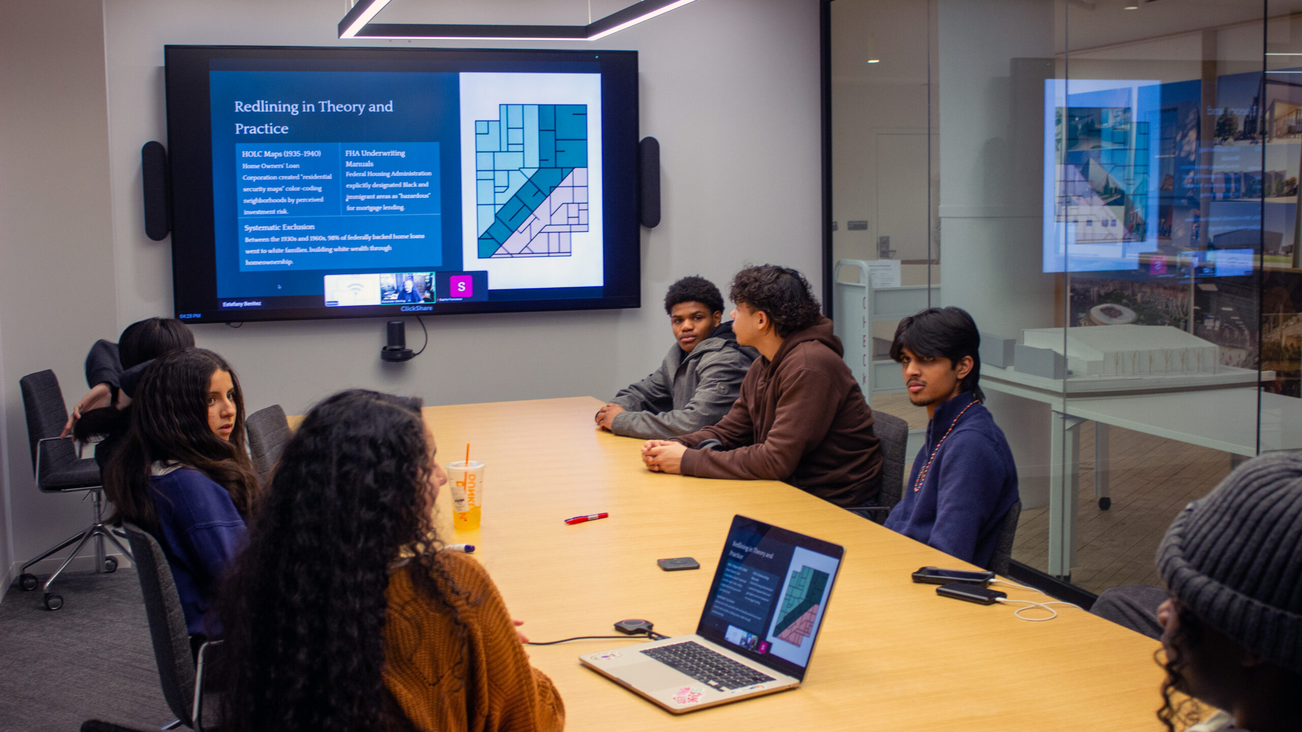 high school students in a conference room listening to a presentation